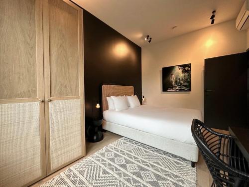 a small bedroom with a bed and a closet at 3 Bedroom Art-Nouveau Apartment with Free Parking in Ghent