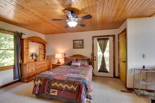 a bedroom with a bed and a ceiling fan at Hot Tub, Game Tables and Mtn Views Ellijay Cabin in Ellijay