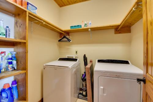 a small laundry room with a washer and dryer at Hot Tub, Game Tables and Mtn Views Ellijay Cabin in Ellijay