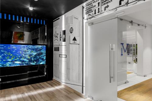 a room with a tv and a large aquarium at Villa Monument Hotel in Lagos