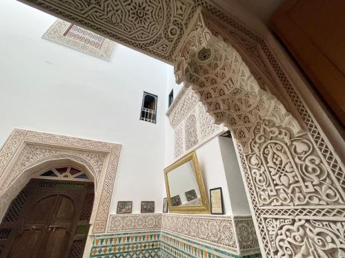 an entrance to a mosque with a door and a mirror at Dar Sunrise Fes in Fès