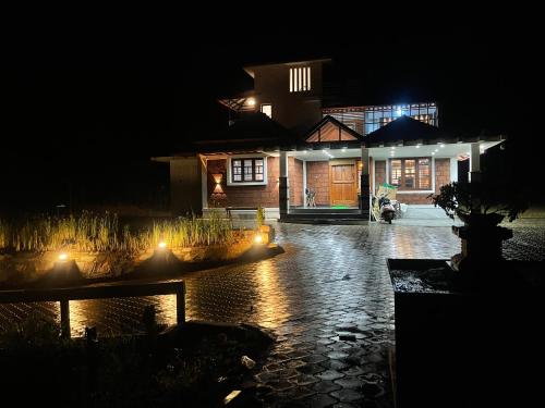 a house at night with lights in front of it at Matsyaangana Homestay in Sringeri