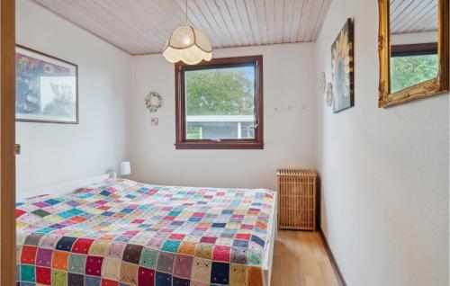 a bedroom with a bed with a colorful quilt at Cozy Home In Store Fuglede With Wifi in Store Fuglede