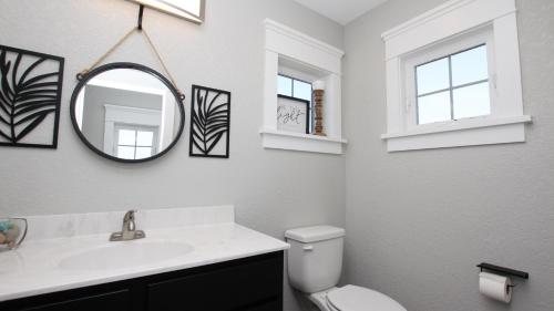 a bathroom with a sink and a mirror and a toilet at Semi-Oceanfront, Ocean Views, Wild Horses, Private Pool, 4x2338, Race To The Beach in Knotts Island