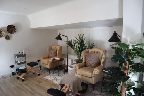 a living room with two chairs and a table at Holbrook Manor & Spa in Wincanton