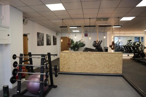 a gym with exercise equipment and a counter at Holbrook Manor & Spa in Wincanton