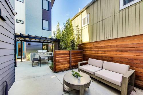 a patio with a couch and a table at Brand New Luxury Fully Furnished Studio Suite in Oakland