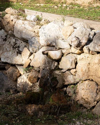 a rock wall with a bunch of rocks at Hidden Stone Chalet in Zarouhla