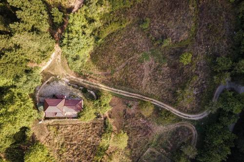 an aerial view of a house on a hill with a road at Hidden Stone Chalet in Zarouhla