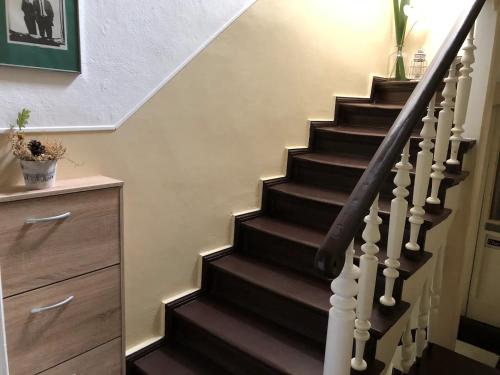 a stairwell with a wooden staircase with a wooden stair case at Zum Fuchsbau - Schöneiche bei Berlin in Schöneiche