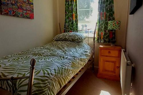 a small bedroom with a bed and a window at Wolds View Hideaway in Scarborough