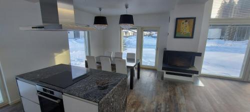 a kitchen and dining room with a table and a fireplace at VILLA MARIA in Turku