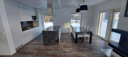 a kitchen with a table and a dining room at VILLA MARIA in Turku