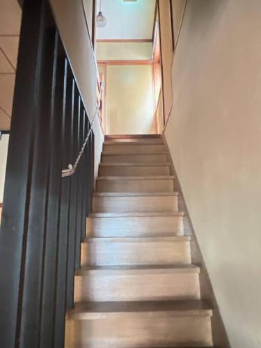 a stairway in a building with stairs leading up at 窓から海の見える静かな貸切一軒家 Dragon Sea Side House BBQ可 in Minamichita