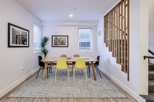 a dining room with a table and yellow chairs at Fully-Stocked Studio Suite Near Downtown Oakland in Oakland