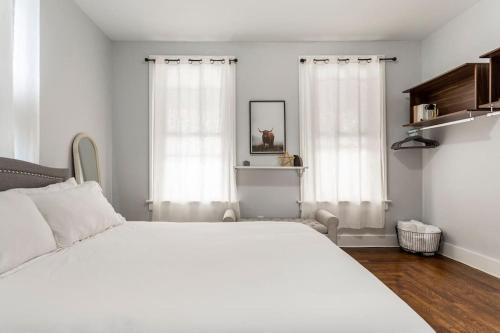 a bedroom with a large white bed and white curtains at The Santiago Yale New Haven with Parking and Modern in New Haven