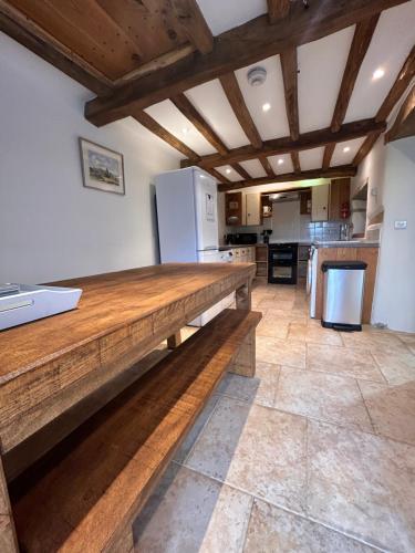 a kitchen with a wooden counter top in a room at Swallows Barn in Penrith