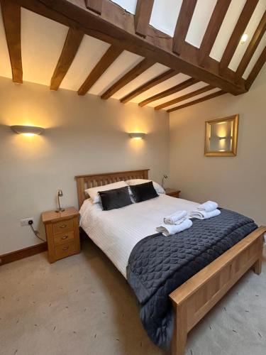 a bedroom with a large bed in a room at Swallows Barn in Penrith