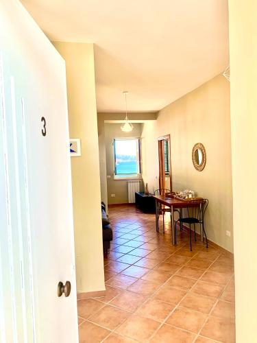 a hallway with a table and a dining room at Artis Mare in Pozzuoli