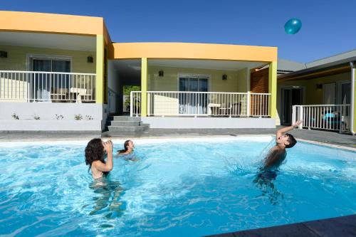 a group of people playing in a swimming pool at LE MALAYA in Saint-Joseph