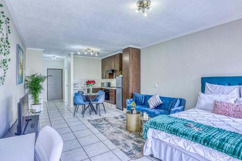 a bedroom with a bed and a living room at Serene Retreat on Sandton in Sandton