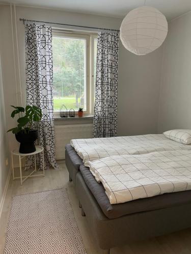 a bedroom with a large bed and a window at Harju Apartment in Jyväskylä