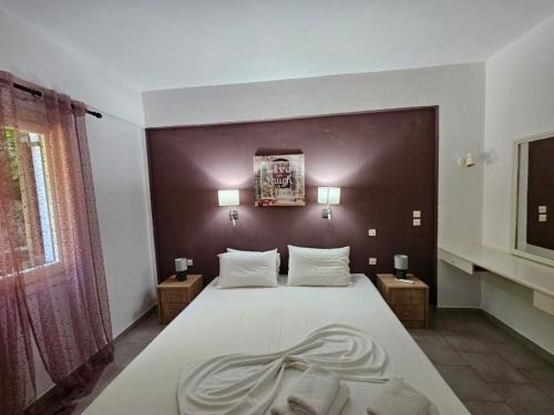 En eller flere senge i et værelse på Corfu Dream Holidays Villas Standart