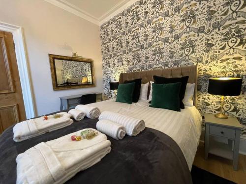 a bedroom with a bed with towels on it at Jorvik Villa in York