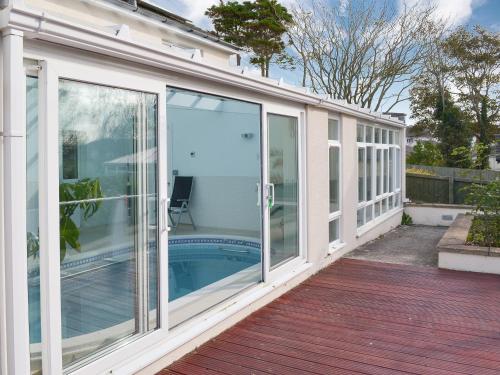a conservatory with sliding glass doors on a house at Riverside in Bude