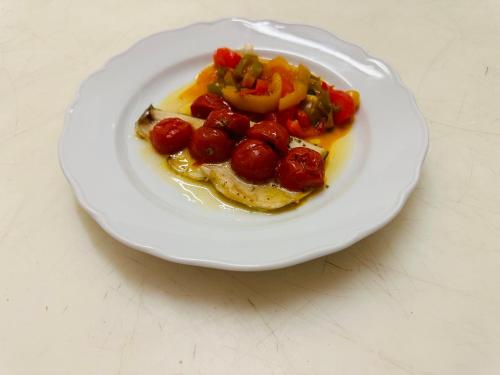 a plate of food with tomatoes and vegetables on it at Centrale in Courmayeur