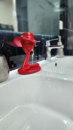 a red stopper sitting on top of a bathroom sink at Location Bastia, U Fiumicellu. Vue Mer. Jacuzzi, Barbecue,... Pour 2 personnes in Bastia