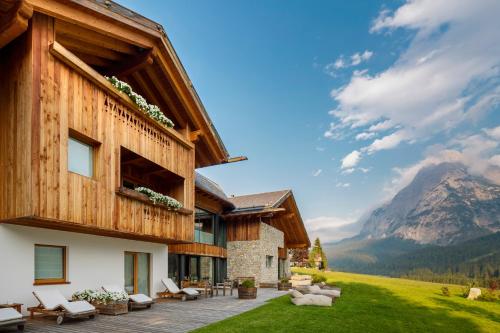 a house in the mountains with a patio at Chalet Le Coccole in Sappada