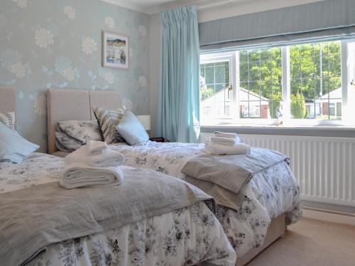 a bedroom with two beds and a window at Coastal Dream in Burton