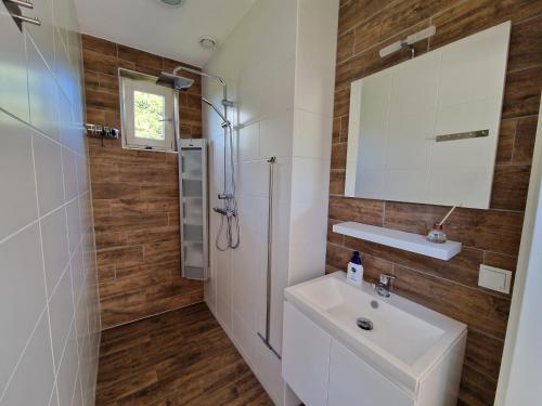 a bathroom with a white sink and a mirror at Bed & Breakfast Inn Drenthe in Fluitenberg
