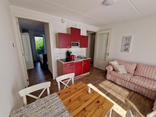 a living room with a couch and a table at Bed & Breakfast Inn Drenthe in Fluitenberg