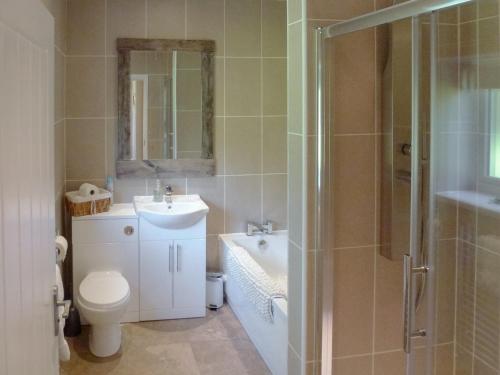 a bathroom with a toilet and a sink and a shower at Old Toads Barn in Theddlethorpe Saint Helen