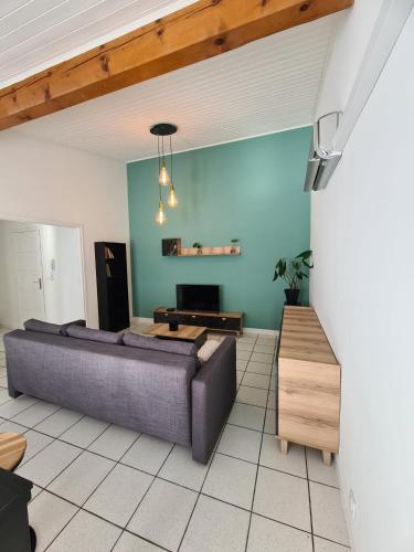 a living room with a couch and a table at Charmant appartement au cœur de Saint-peray in Saint-Péray