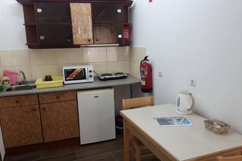 a kitchen with a sink and a counter top at Casa das Matriarcas- Casa da Avó Raquel in Belmonte