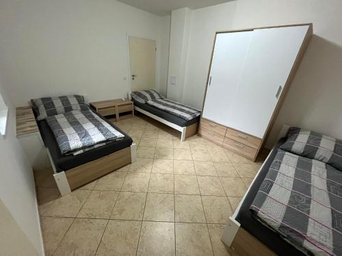 a room with two beds and a mirror at Ubytování Pardubice Trnová in Pardubice