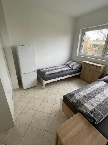 a room with two beds and a window at Ubytování Pardubice Trnová in Pardubice