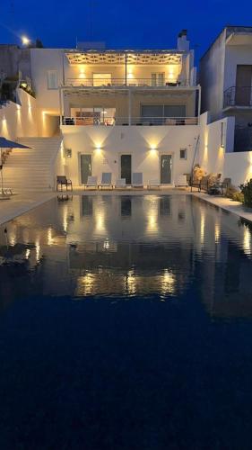 a swimming pool in front of a building at night at Zahra Superior Suite with private pool in Sannicola