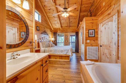 a bathroom with a tub and a bedroom with a bed at Always in Gatlinburg