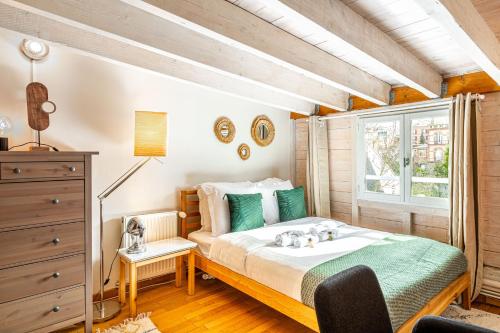 a bedroom with a bed and a window at Art & Curiosity Cabinet Style Appartement with Paris view, Villa des Ammonites in Meudon