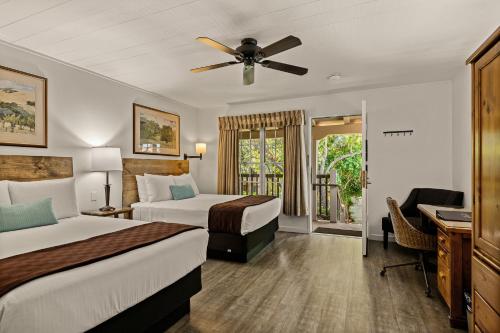 a hotel room with two beds and a ceiling fan at El Pueblo Inn in Sonoma