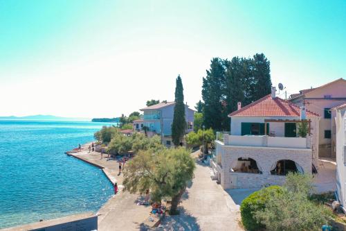 a view of a beach with buildings and the water at Villa Mare Vista in Žman