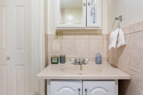 a bathroom with a sink and a mirror at The Matisse at Wooster Square Yale with Parking in New Haven