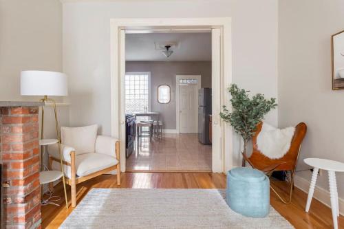a living room with a couch chairs and a table at The Matisse at Wooster Square Yale with Parking in New Haven