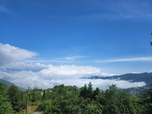 a view of the mountains with clouds in the sky at THEN'S HOUSE Y TÝ in Phan Kơng Su