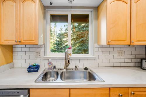a kitchen with a sink and a window at Eagle River Getaway in Eagle River