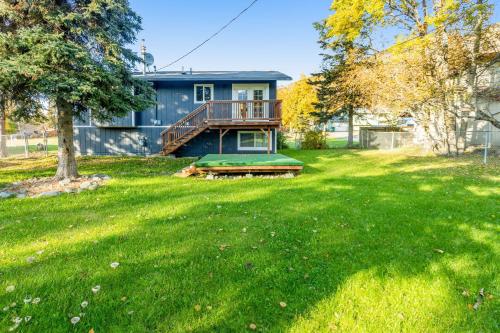 a house with a green yard in front of it at Eagle River Getaway in Eagle River